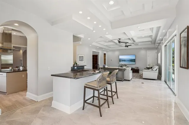a kitchen with stainless steel appliances kitchen island granite countertop a sink and cabinets