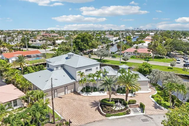 an aerial view of a house with a swimming pool yard and outdoor seating