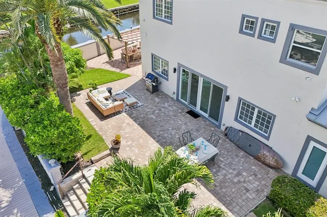 a view of a swimming pool with outdoor seating and a garden