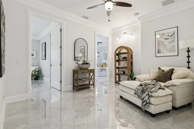a living room with furniture a couch and a chandelier