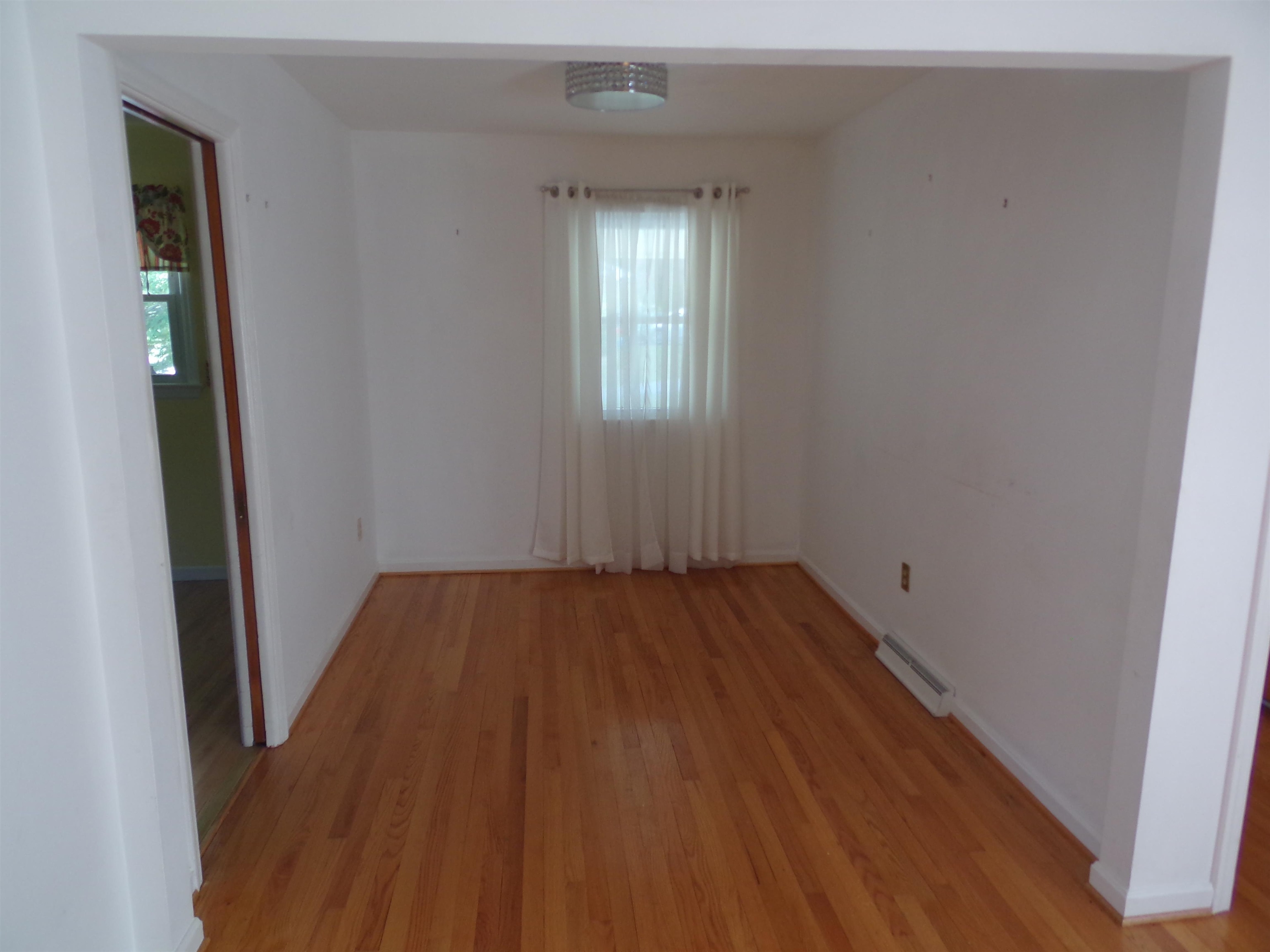 1728 Rockfish Road Waynesboro, VA 22980 - Photo 11 of 42 an empty room with wooden floor and windows