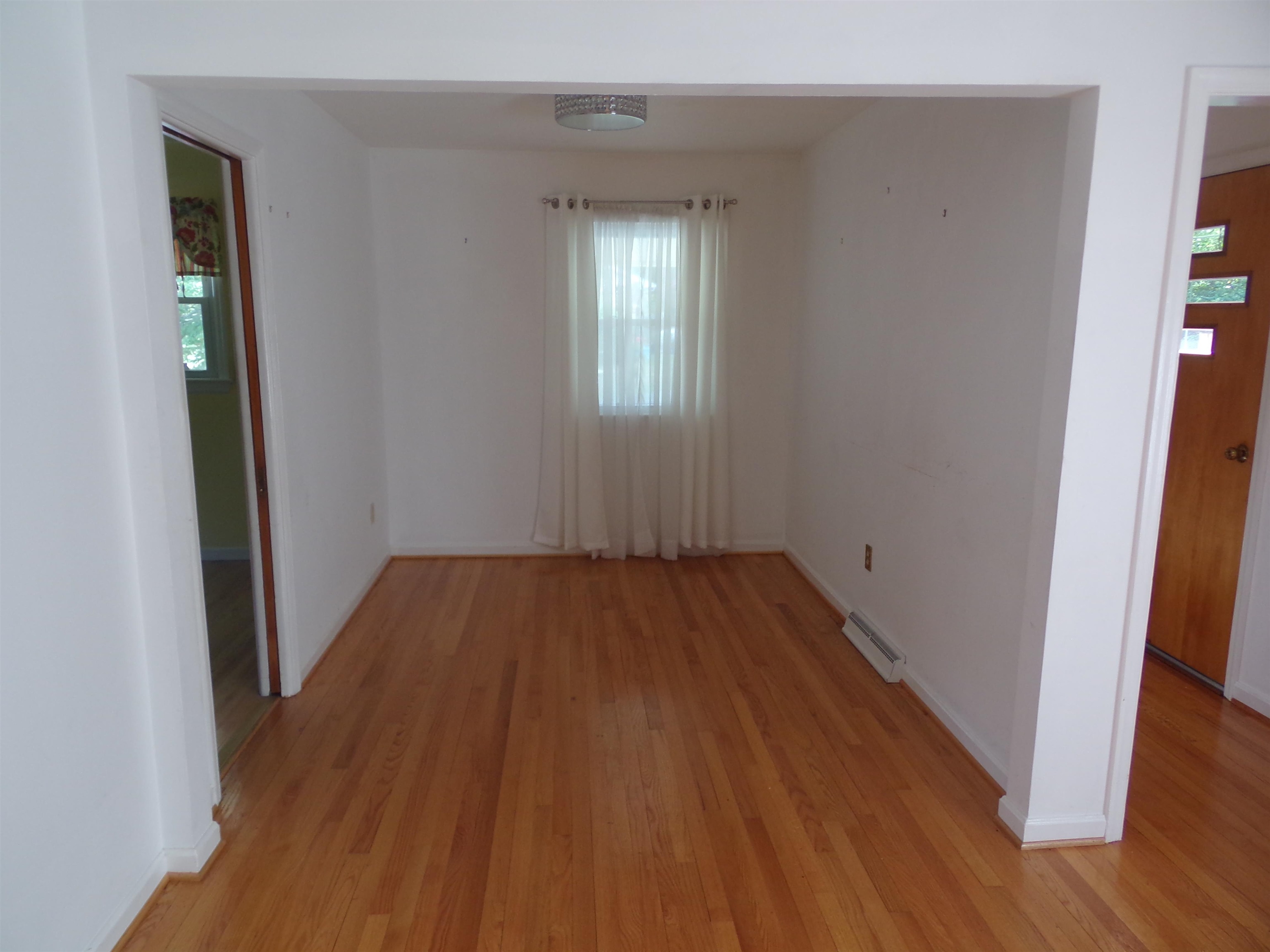 1728 Rockfish Road Waynesboro, VA 22980 - Photo 12 of 42 an empty room with wooden floor and windows