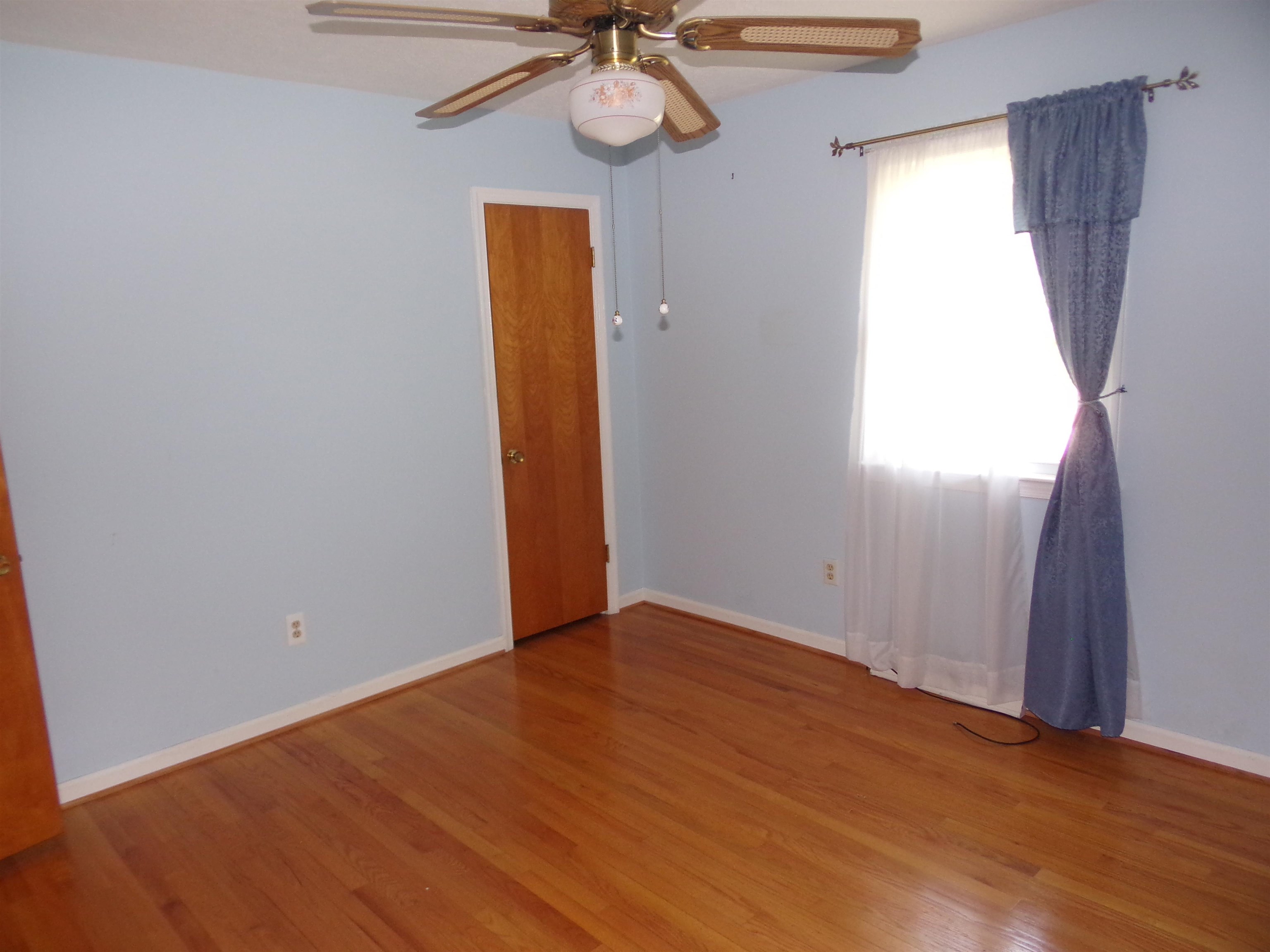 1728 Rockfish Road Waynesboro, VA 22980 - Photo 20 of 42 an empty room with wooden floor fan and windows