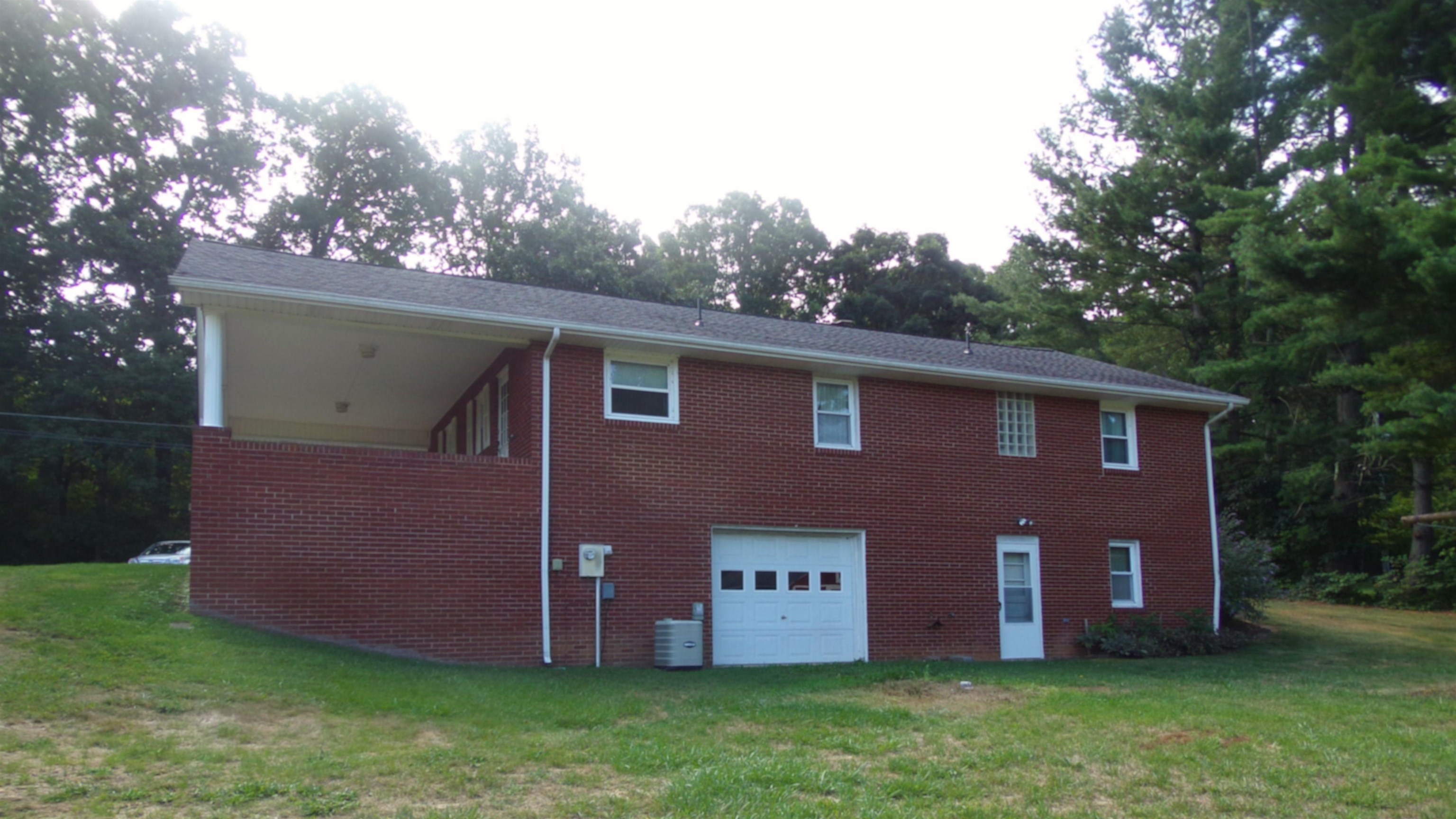 1728 Rockfish Road Waynesboro, VA 22980 - Photo 4 of 42 a front view of house with yard and trees in the background