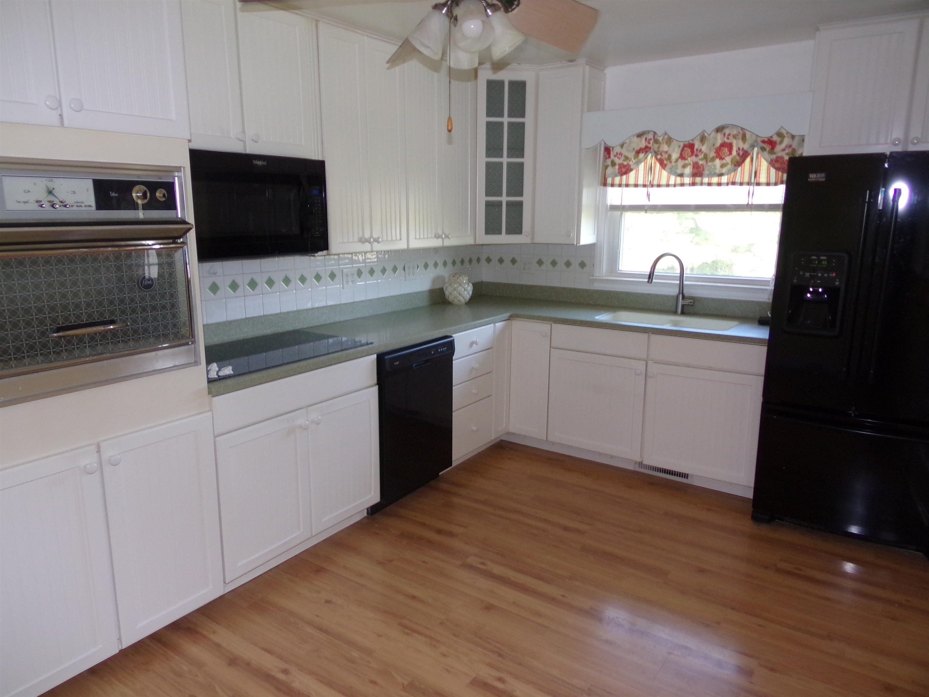 1728 Rockfish Road Waynesboro, VA 22980 - Photo 8 of 42 a kitchen with stainless steel appliances granite countertop a sink and microwave with wooden floors