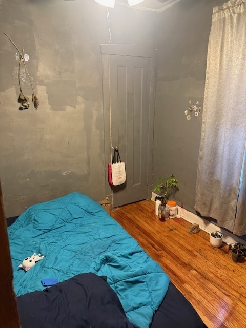 907 South 10th Avenue Maywood, IL 60153 - Photo 11 of 12 a bedroom with a bed and a chandelier