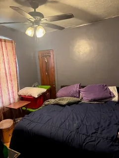 a bedroom with two beds and a chandelier