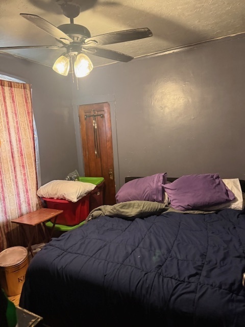 907 South 10th Avenue Maywood, IL 60153 - Photo 12 of 12 a bedroom with two beds and a chandelier