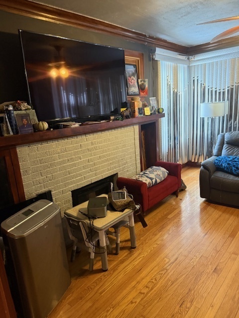 907 South 10th Avenue Maywood, IL 60153 - Photo 3 of 12 a living room with furniture and a flat screen tv
