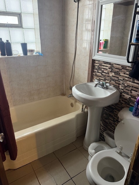 907 South 10th Avenue Maywood, IL 60153 - Photo 8 of 12 a bathroom with a sink toilet and shower