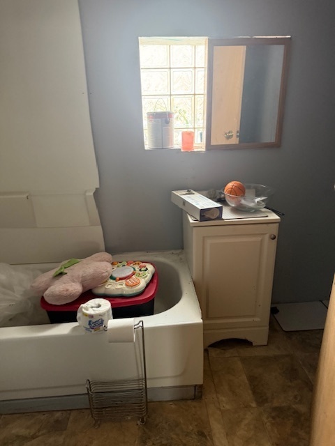 907 South 10th Avenue Maywood, IL 60153 - Photo 9 of 12 a bathroom with a sink and a window