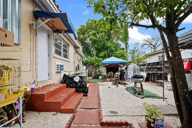 a bedroom with a bed closet and a large mirror on the dresser