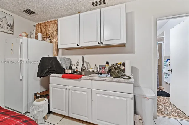 a bathroom with a sink a toilet and a shower curtain