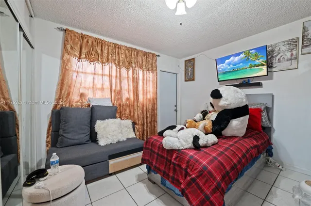 a view of a patio filled with furniture and umbrella