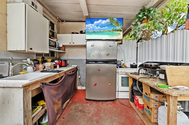 a view of a patio with table and chairs and potted plants