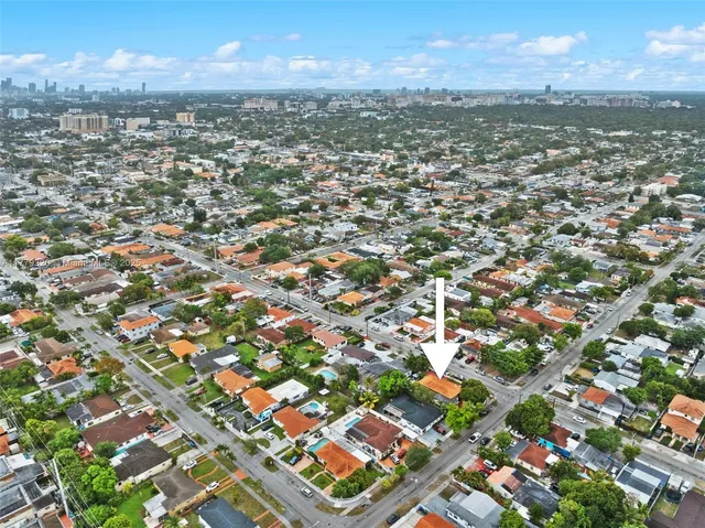 an aerial view of residential houses with city view