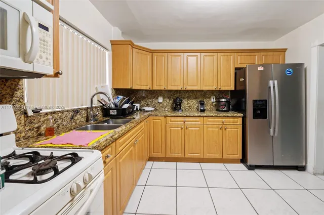 a kitchen with a sink a stove and refrigerator
