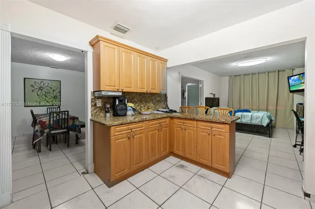 a kitchen with stainless steel appliances granite countertop a refrigerator and microwave