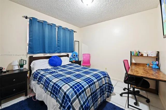 a bedroom with a bed and a desk