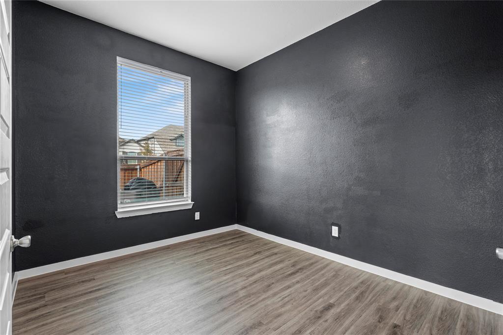 1805 Lockhart Drive Forney, TX 75126 - Photo 10 of 22 Unfurnished room with a textured wall and wood finished floors