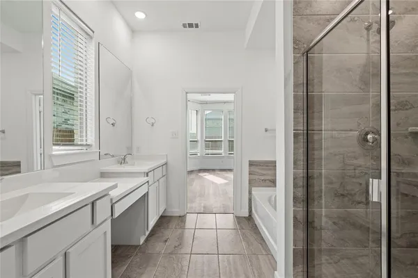 a bathroom with a granite countertop sink a toilet and shower