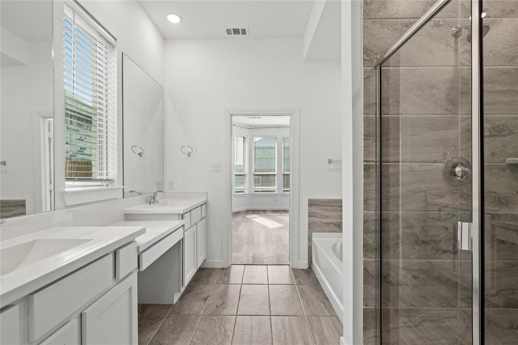 1805 Lockhart Drive Forney, TX 75126 - Photo 14 of 22 Full bathroom featuring a bath, double vanity, a shower stall, and recessed lighting