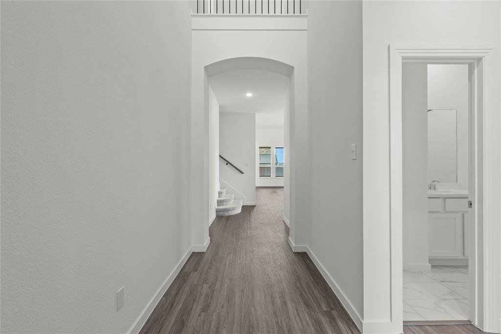 1805 Lockhart Drive Forney, TX 75126 - Photo 2 of 22 Corridor featuring arched walkways, dark wood-type flooring, and recessed lighting