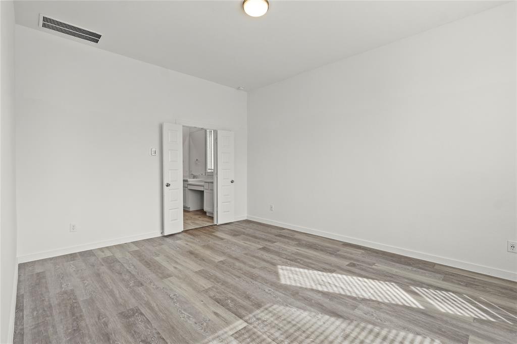 1805 Lockhart Drive Forney, TX 75126 - Photo 5 of 22 Unfurnished bedroom featuring light wood-style floors and ensuite bath