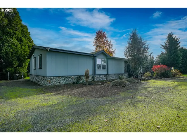 a view of a house with swimming pool and a yard