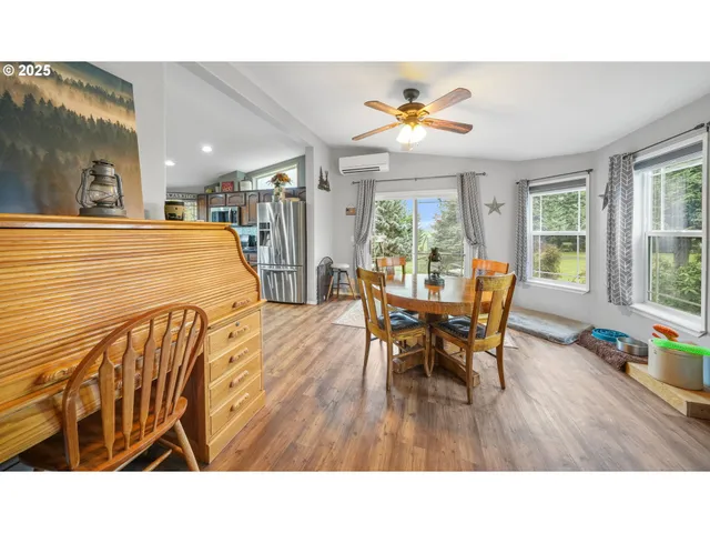 a dining room with furniture a rug and a large window