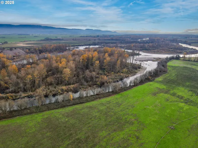 an aerial view of a golf course with a lake view