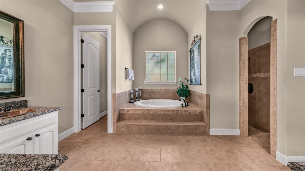840 Hensley Road Gordon, TX 76453 - Photo 24 of 40 Full bathroom featuring a garden tub, ornamental molding, vanity, baseboards, and a walk in shower