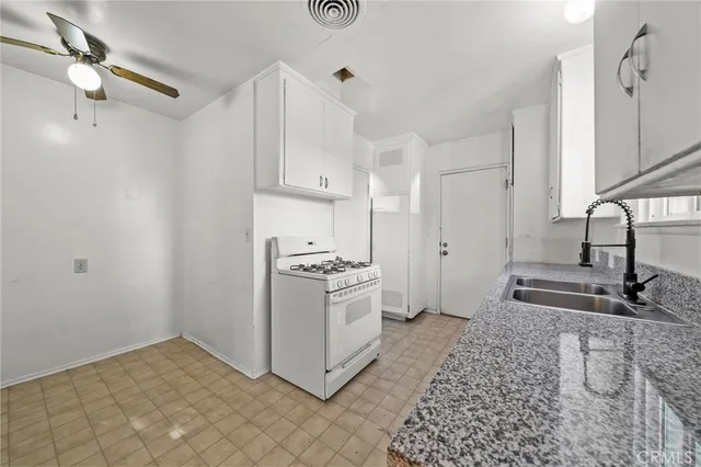 a kitchen with sink cabinets and stove