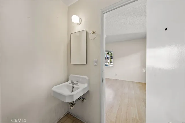a bathroom with a sink a mirror and shower