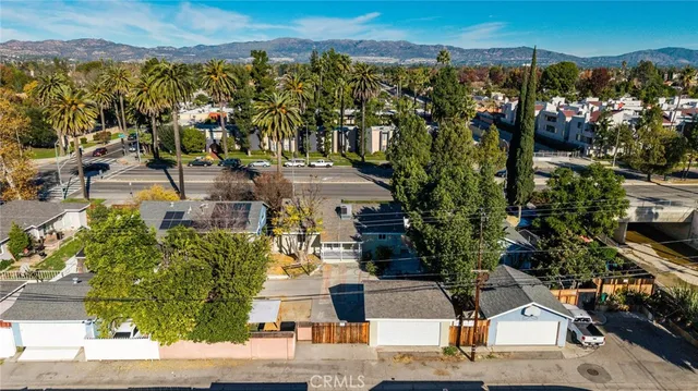 an aerial view of a house with a yard and garden