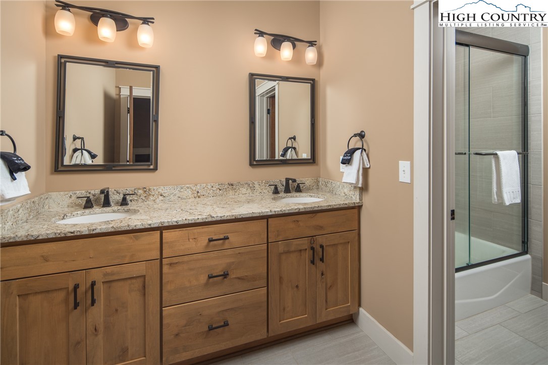 1253 Goldenrod Road Boone, NC 28607 - Photo 23 of 48 a bathroom with double sink and a mirror
