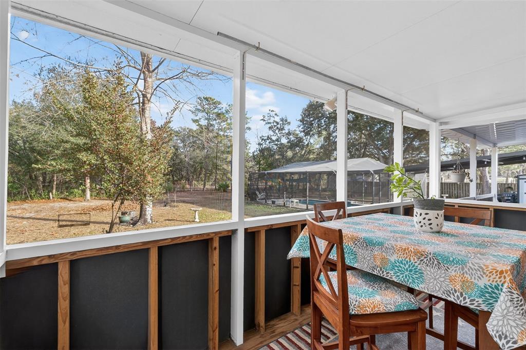 6249 South Esmeralda Terrace Lecanto, FL 34461 - Photo 38 of 61 a dining room with furniture a chandelier and wooden floor