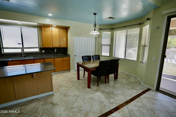 a kitchen with granite countertop sink stove and refrigerator