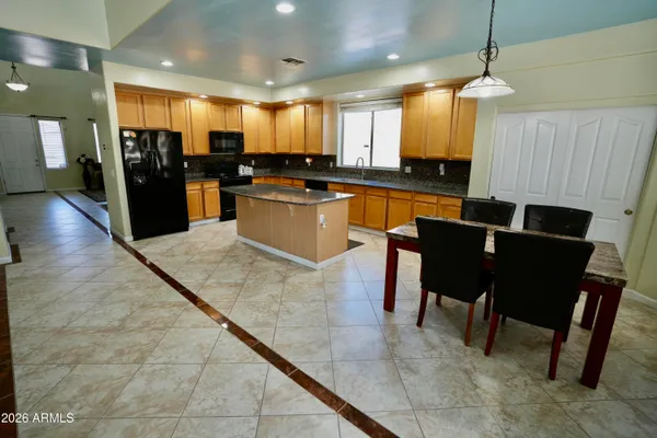 a large kitchen with lots of counter space and breakfast area