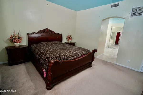 a bed sitting in a bedroom next to a window