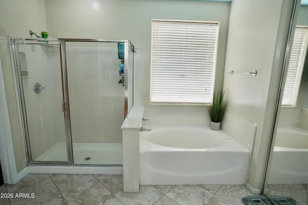 a white bath tub sitting next to a shower
