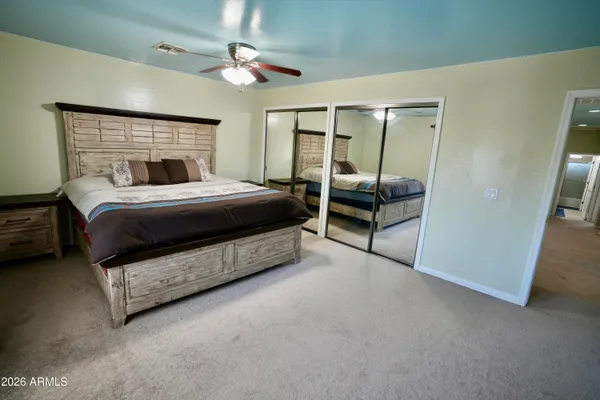 a bedroom with a bed and a mirror