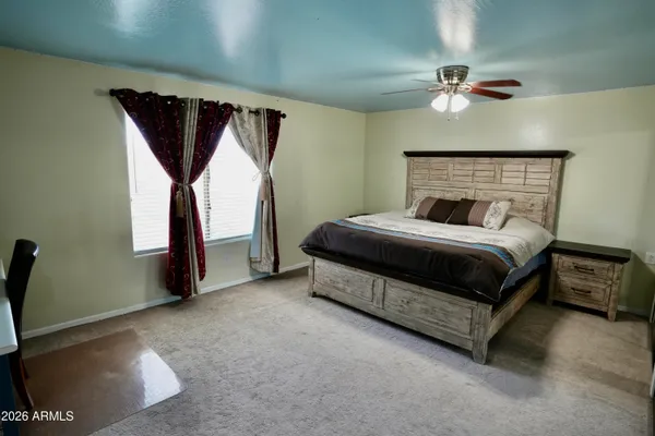 a bedroom with a bed lamp and a fireplace