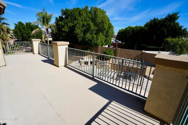 a view of balcony with wooden floor and fence