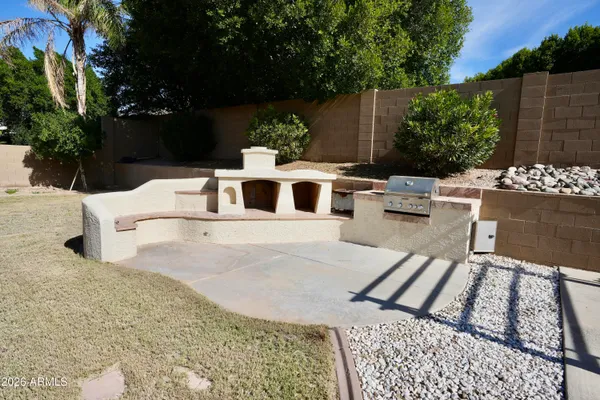 a white house with a yard and seating space