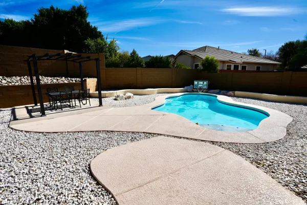 a view of a swimming pool with a yard