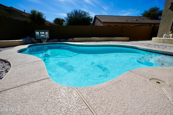 a view of a swimming pool with a yard
