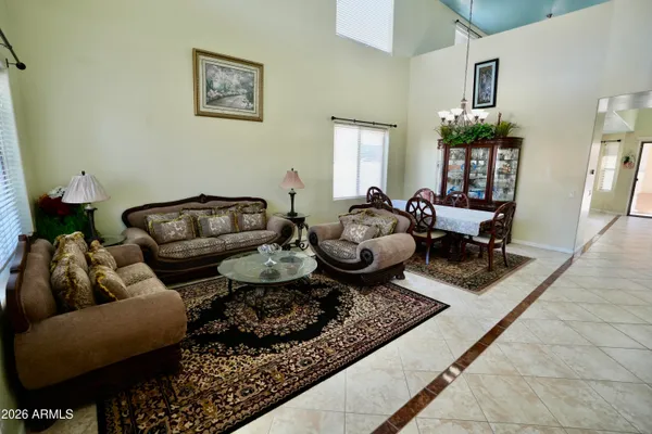 a living room with furniture chess board and a window