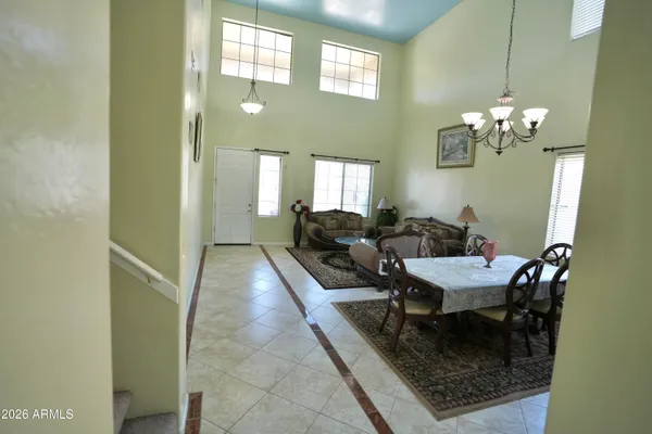 a dining room with furniture and a chandelier