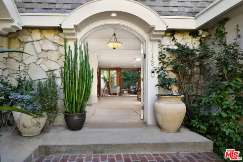 a view of swimming pool with outdoor seating and plants